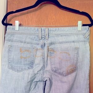 Bebe light colored flare jeans with beaded design on back. Size 28.